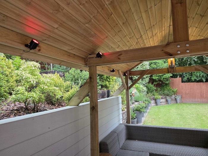 Spotlights installed under a garden pergola