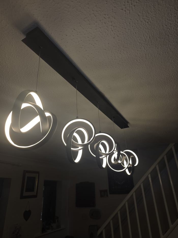 Statement pendant lights installed above a staircase
